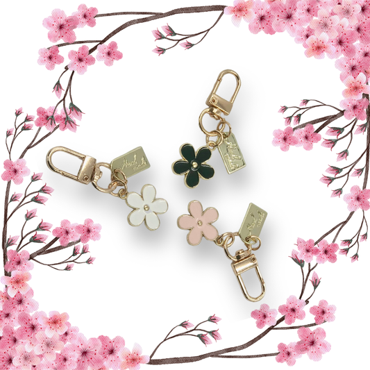 Blossom shaped handbag charms with cherry blossom branches and white background