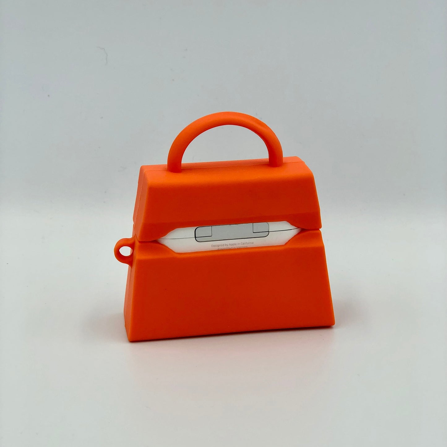 Orange Silicone Handbag Airpod Case - Back view. Apple AirPods and Apple Airpod case are for reference only and are not included.
