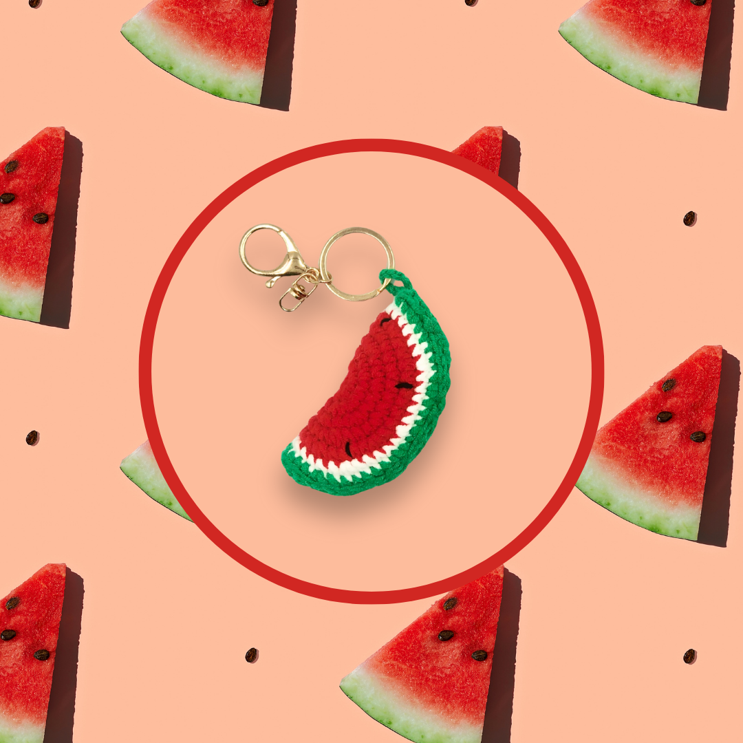 Watermelon slice crochet handbag charm on a pink background with watermelon pattern