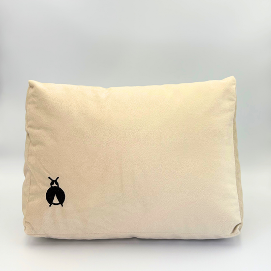 Front of a Beige Handbag Shaper with a black bug logo on a grey background