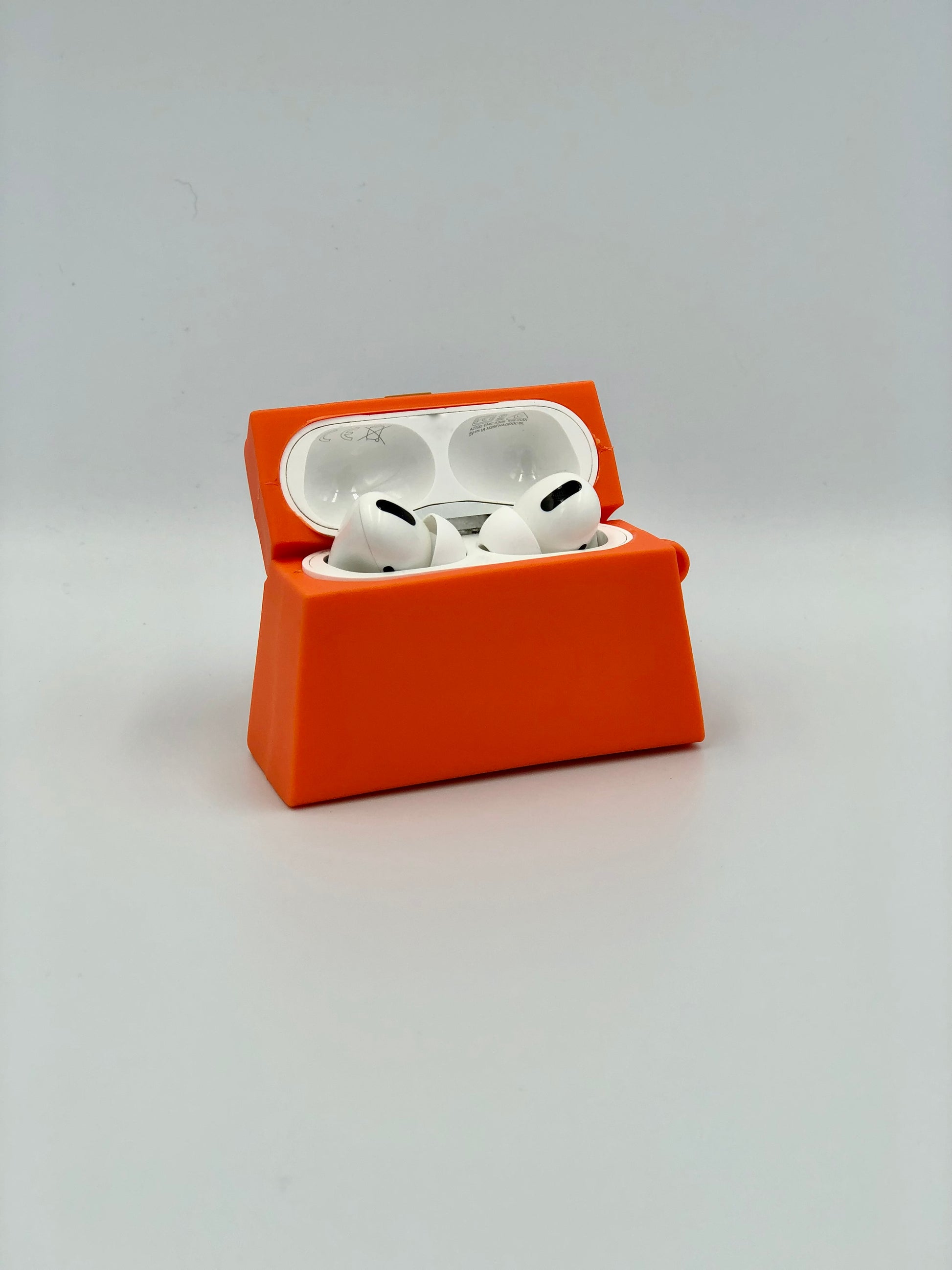 Orange Silicone Handbag Airpod Case - Open view. Apple AirPods and Apple Airpod case are for reference only and are not included.