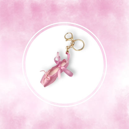 Pink ballet slipper handbag charm on a pink background
