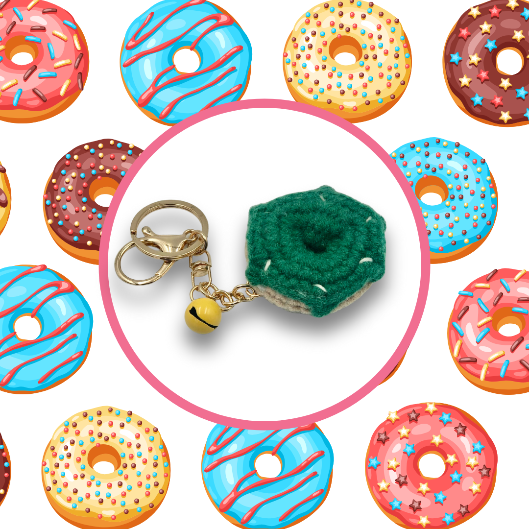 Green donut-shaped crochet handbag charm on a white background with donut pattern