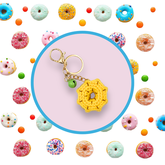 Yellow donut-shaped crochet handbag charm on a lilac background with donut pattern